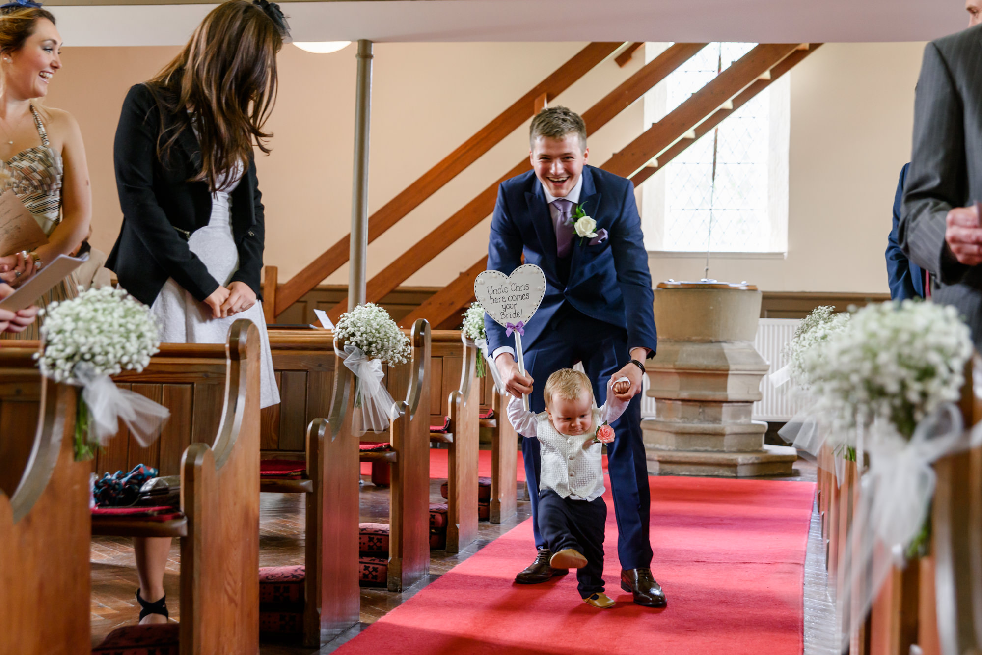 Page boy making an entrance at Parish Church of Saint Michael Whitewell