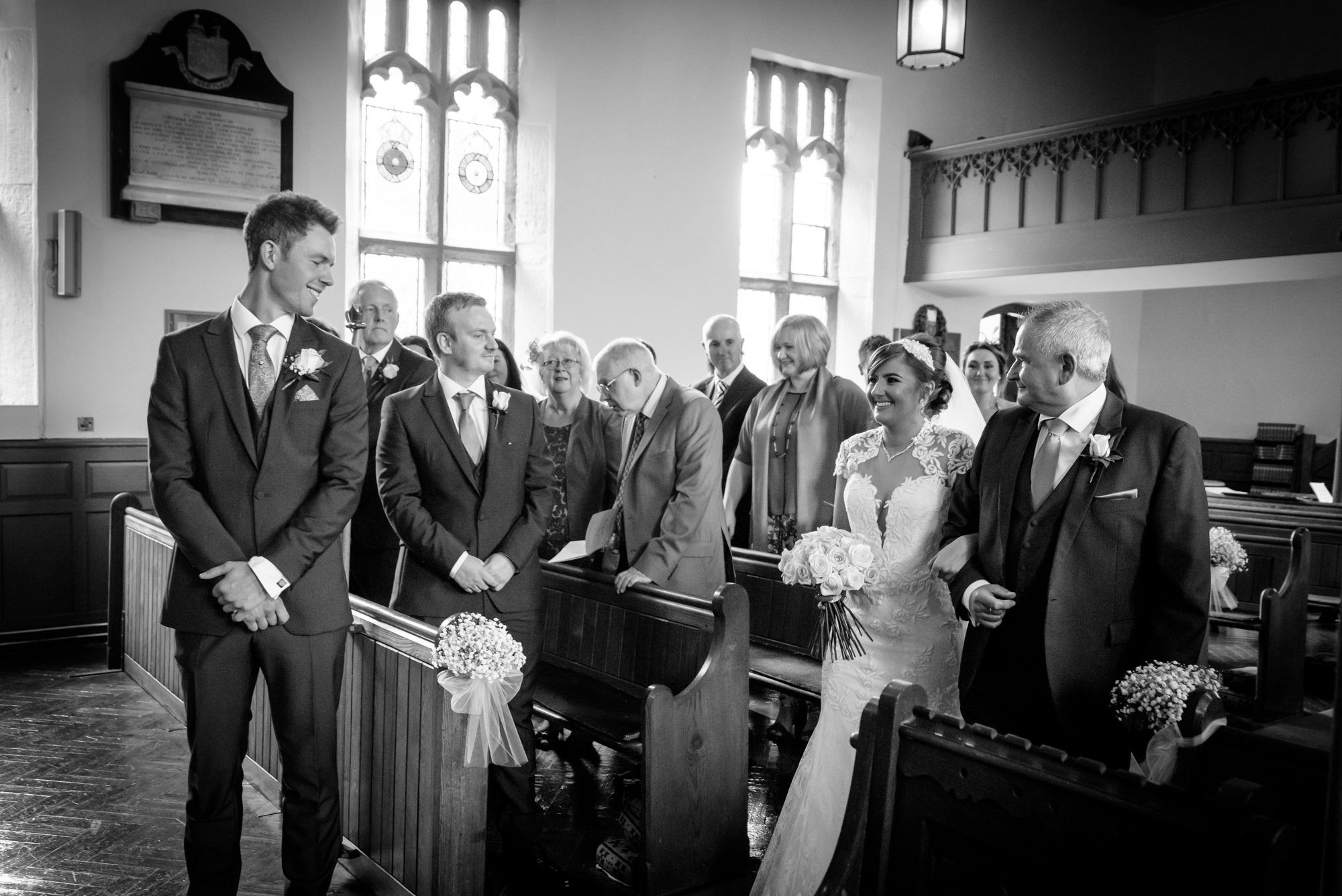 Bride meets the groom down the ailse at the Parish Church of Saint Michael Whitewell