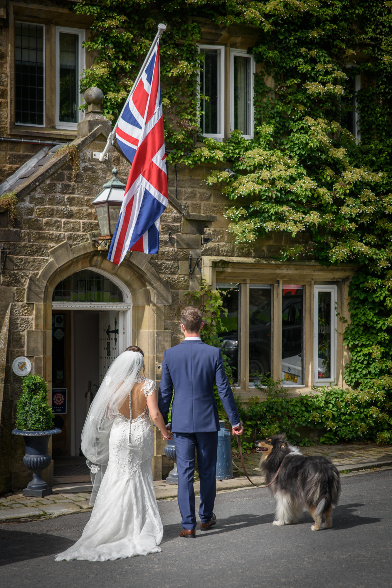 Bride and Groom walking the dog at The inn at Whitewell