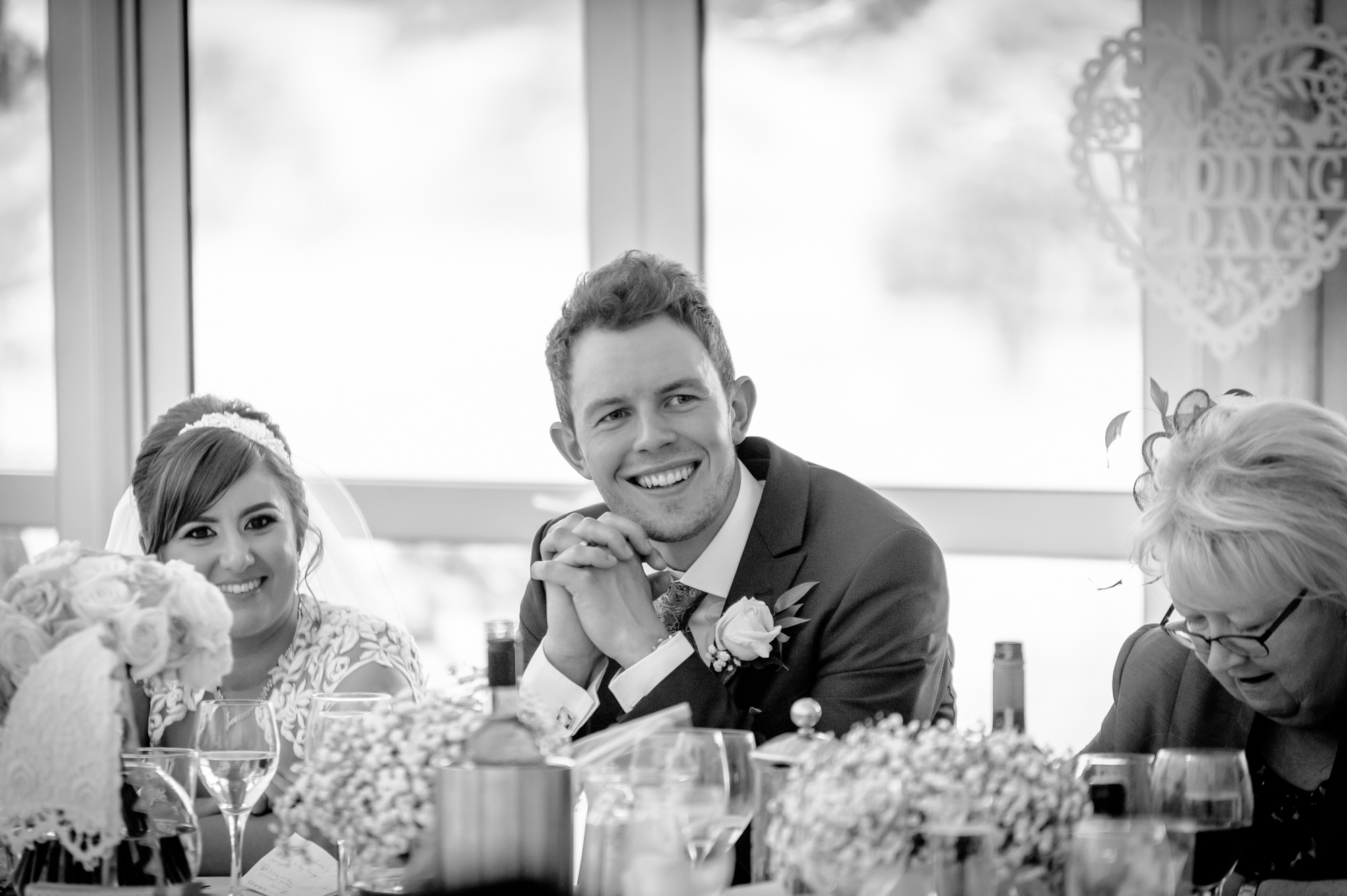 Groom listening to the best man's speech