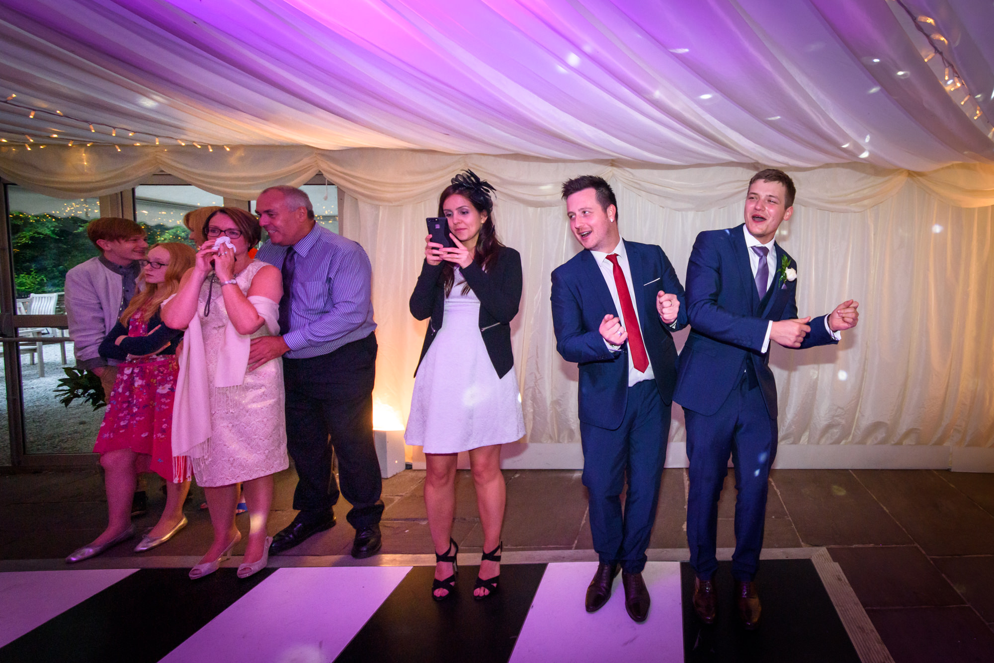 Guests dancing awkwardly on the side of the dance floor