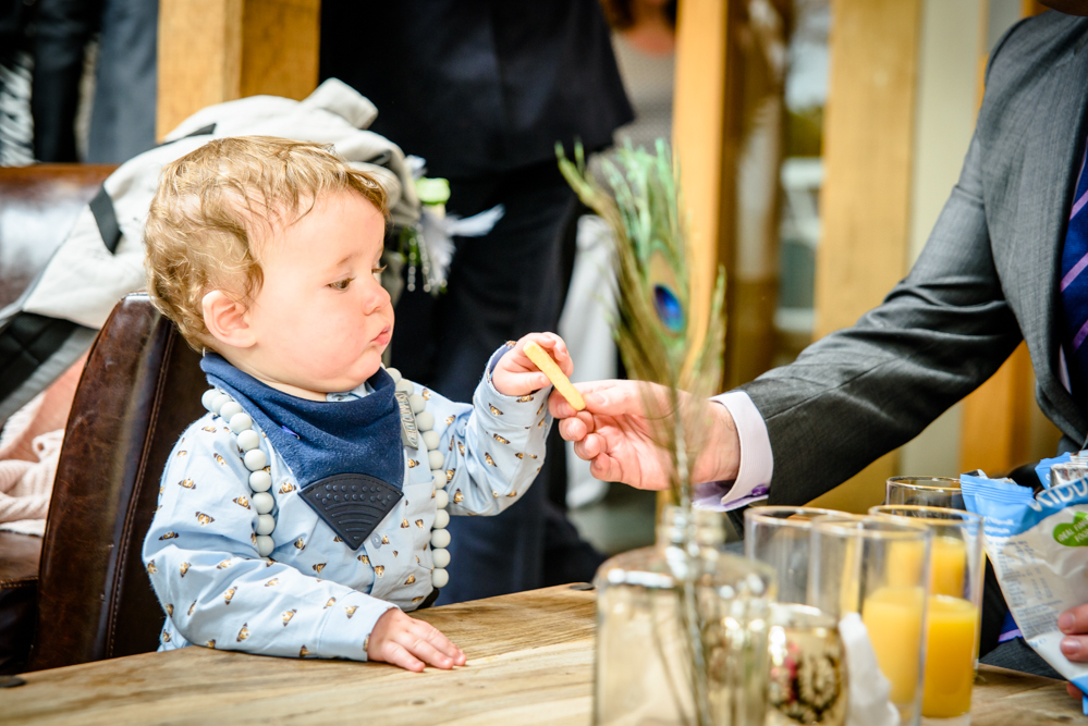 Toddler tasting something during the drink reception