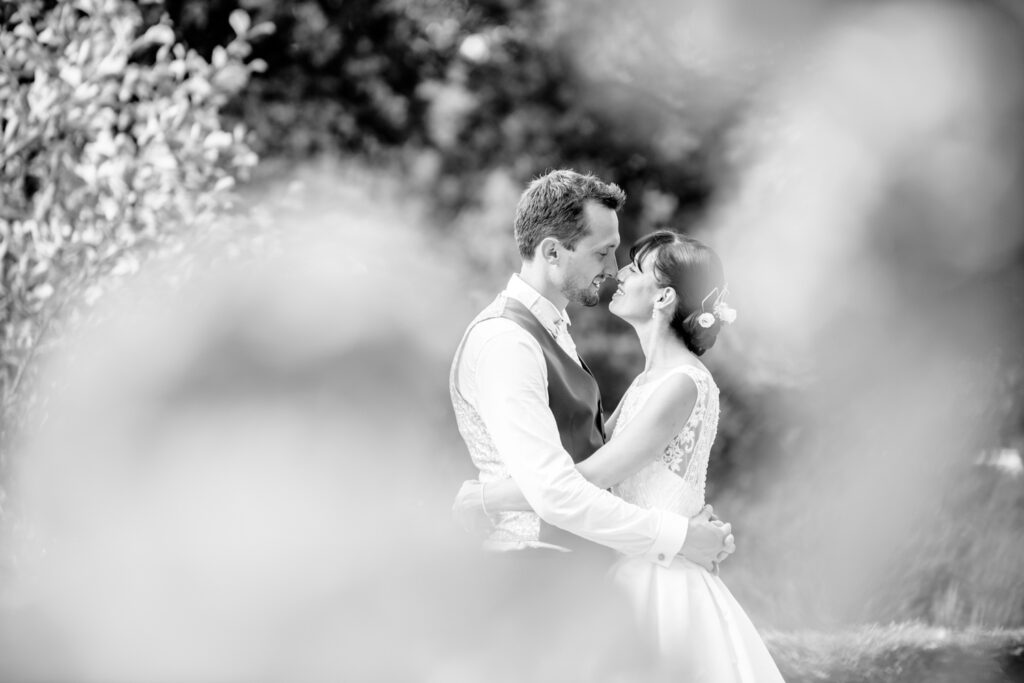 bride and groom photographed through the flowers