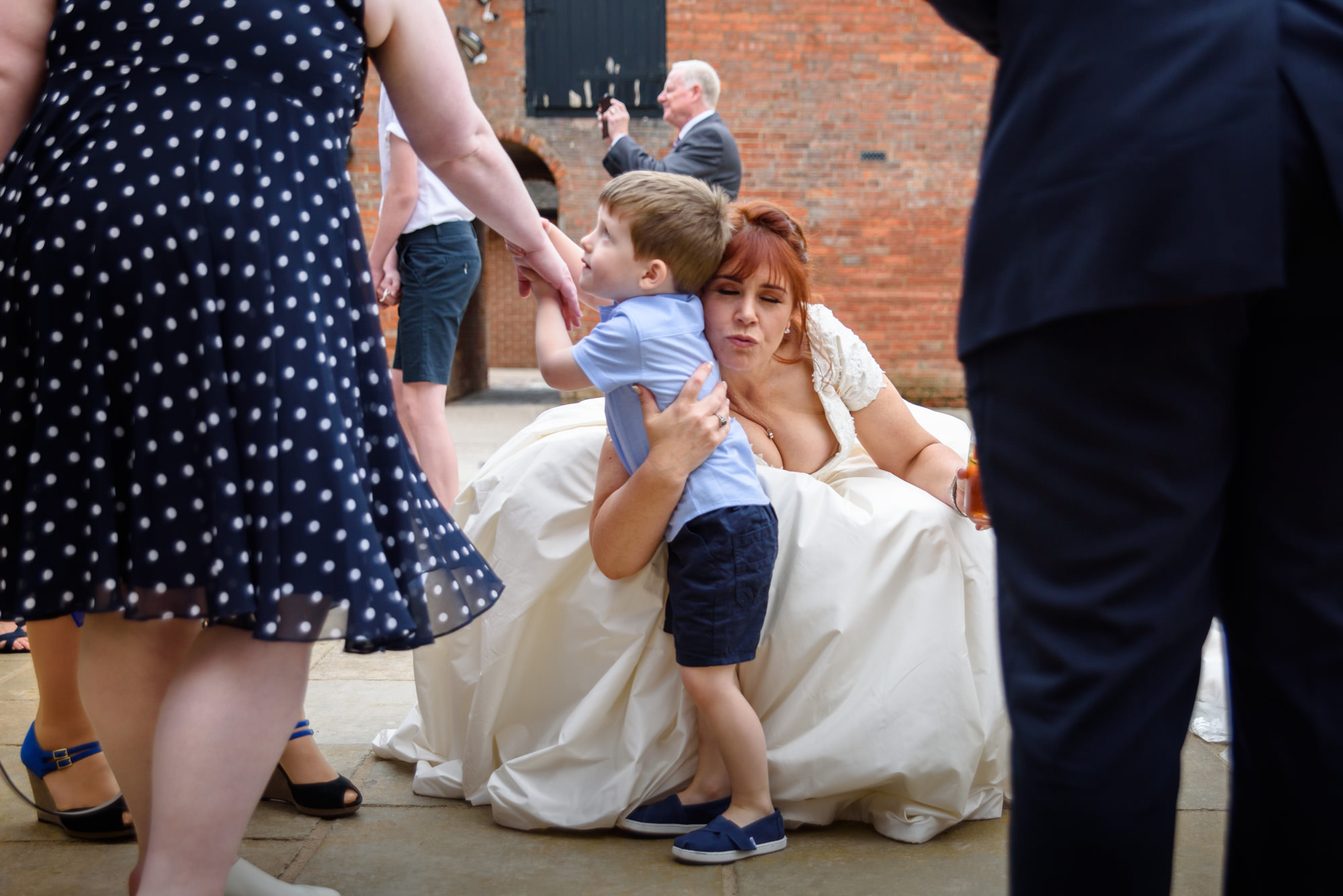 Bride tries to kiss a little boy