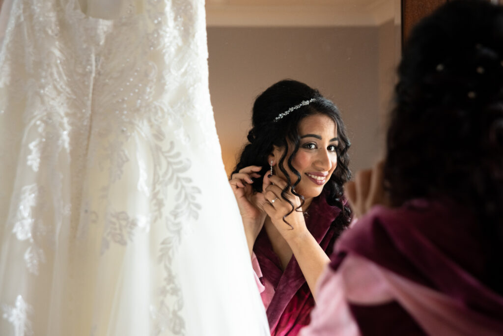 bride putting earring on
