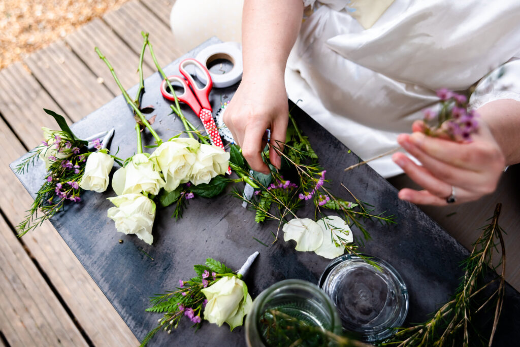 Bride making wedding buttonholes on the wedding day