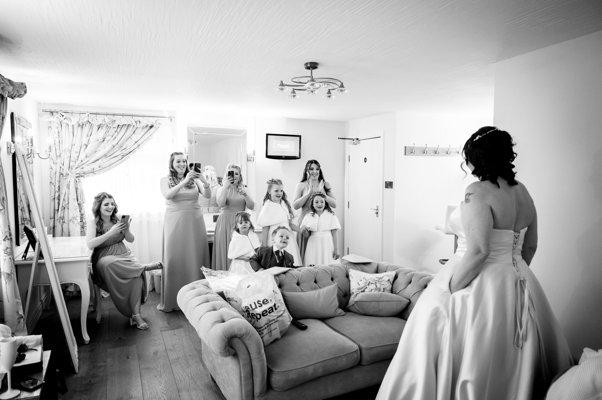 Bridal party sees the bride in her dress for the first time at Sandhole Oak Barn