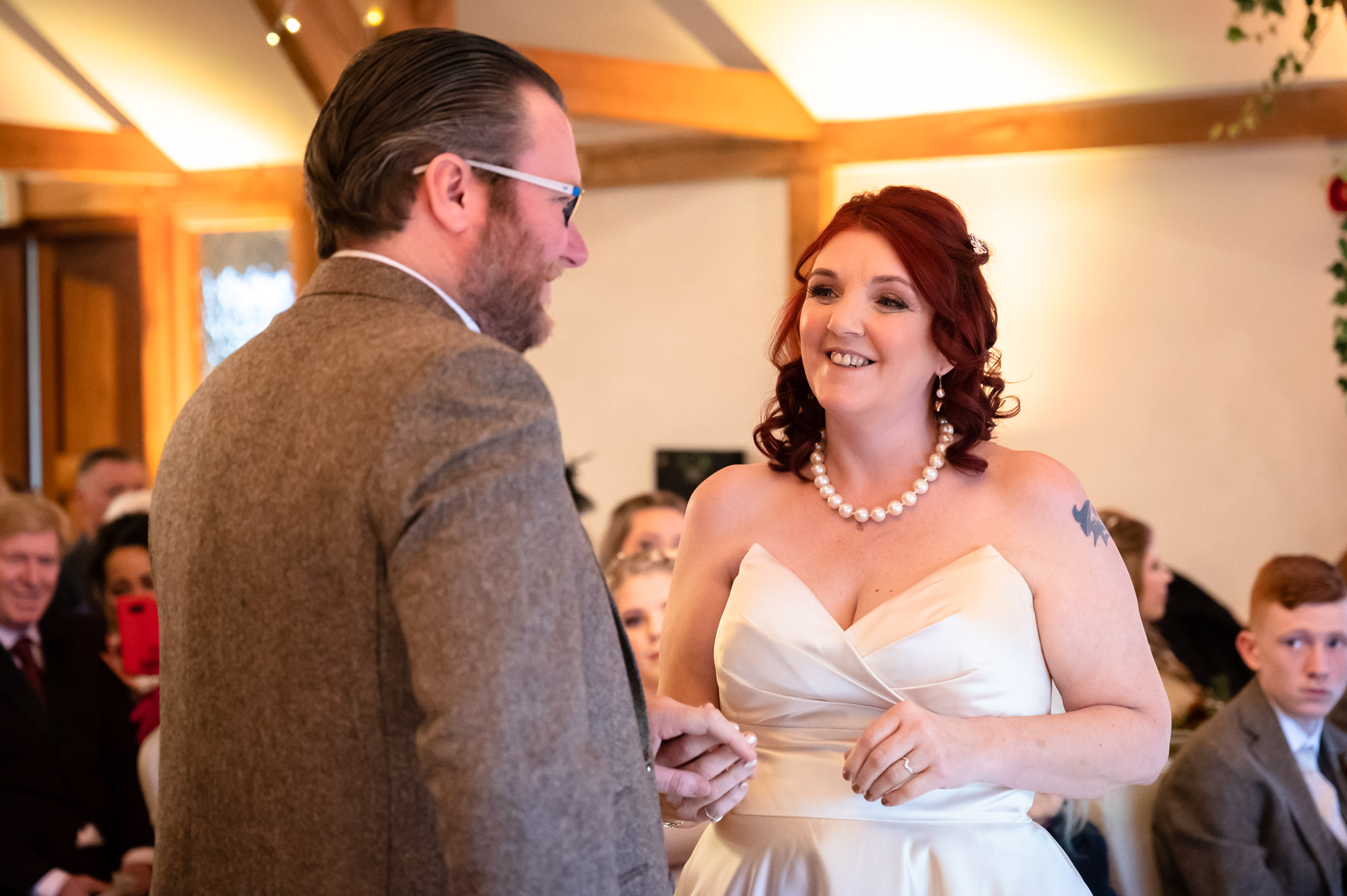 Bride and groom exchanging vows at Sandhole Oak Barn