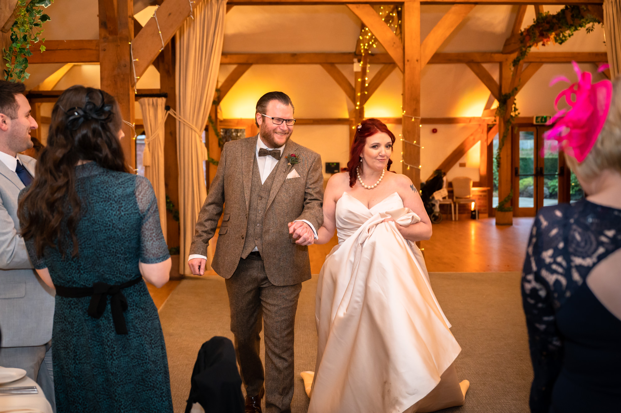 Bride and groom being announced at the new Mr and Mrs Bride and groom exchanging vows at Sandhole Oak Barn