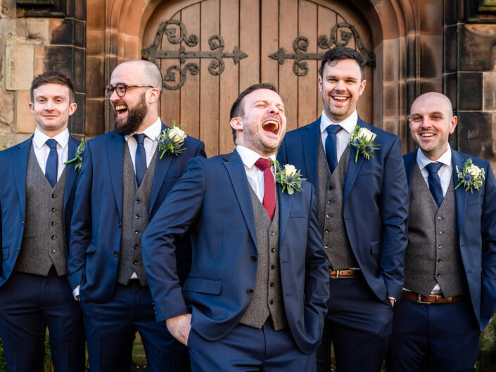 groom and ushers laughing during formal photos