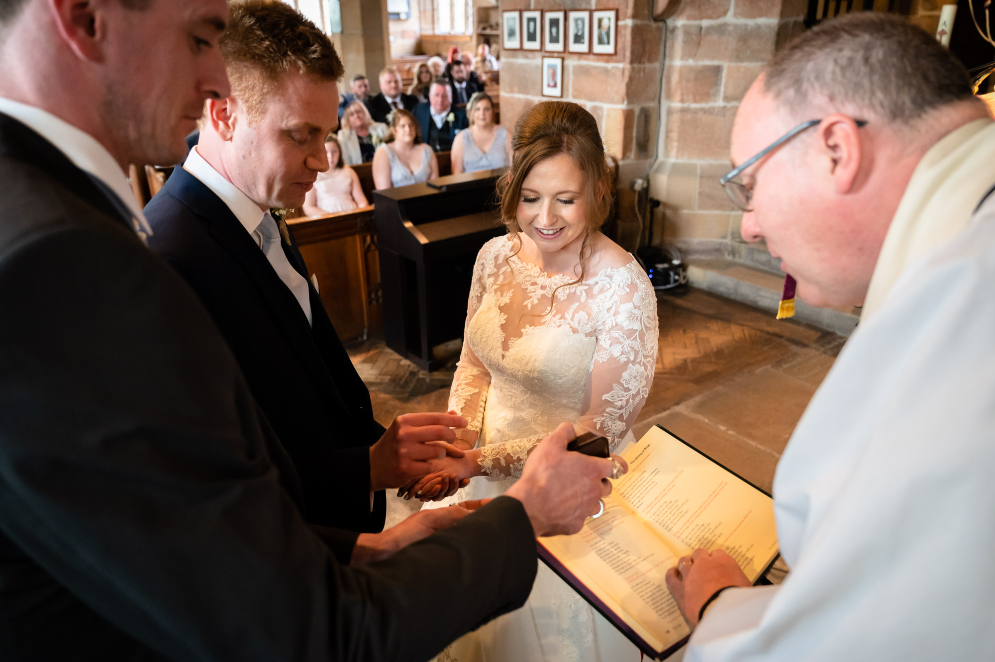 groom picks up the ring at St Michael's Church in Ormskirk