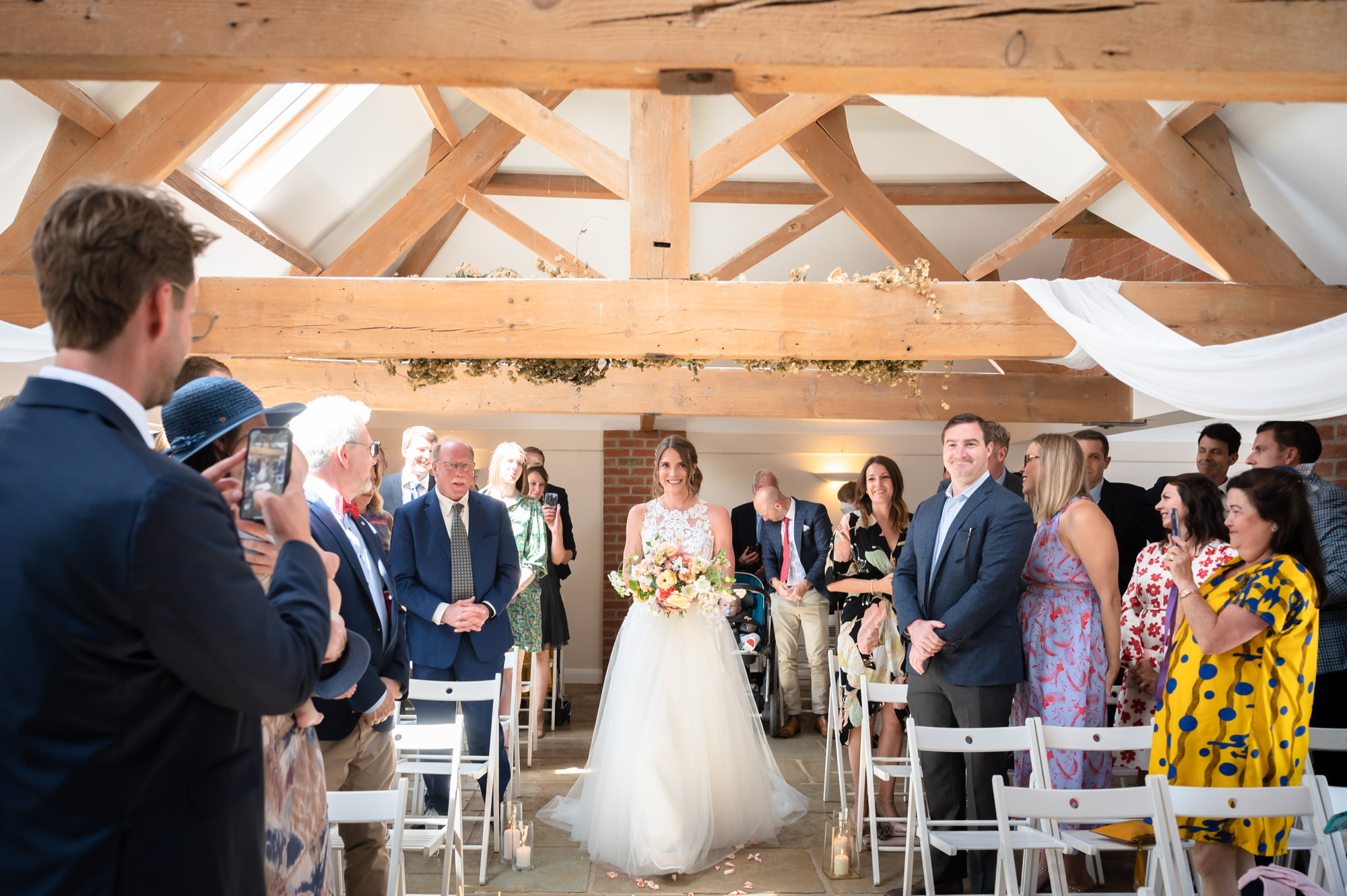 Bride walking down the aisle at Hanbury Wedding Barn