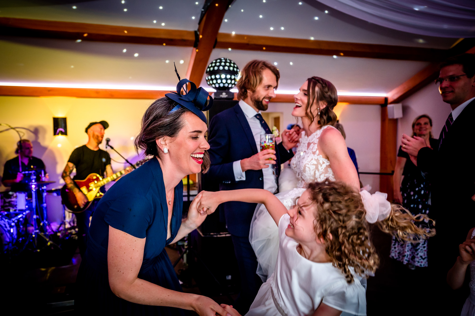 Guest dancing with the flower girl at Hanbury Wedding Barn