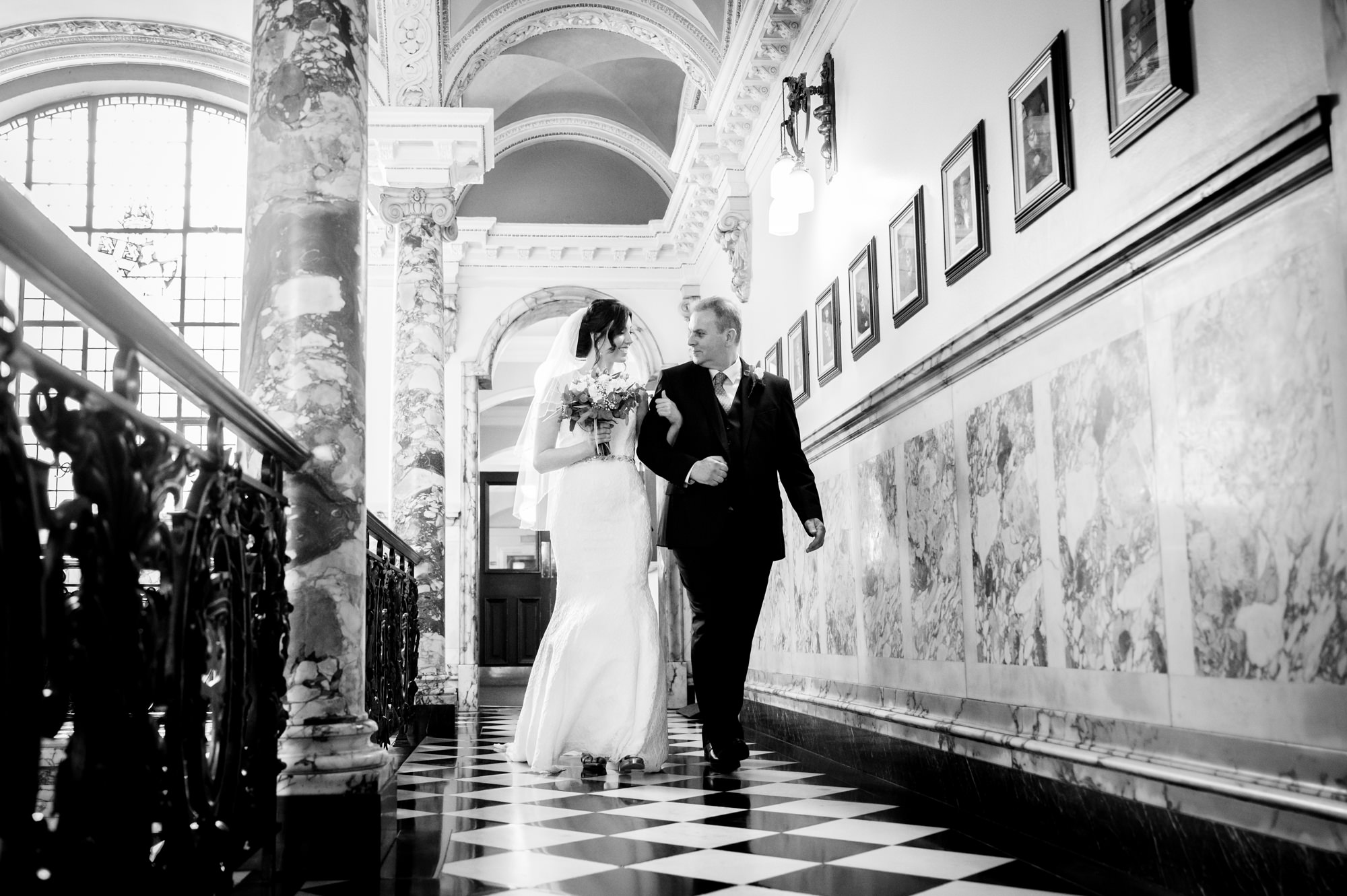 Bride making her way to The Marble Staircase at Stockport Town Hall