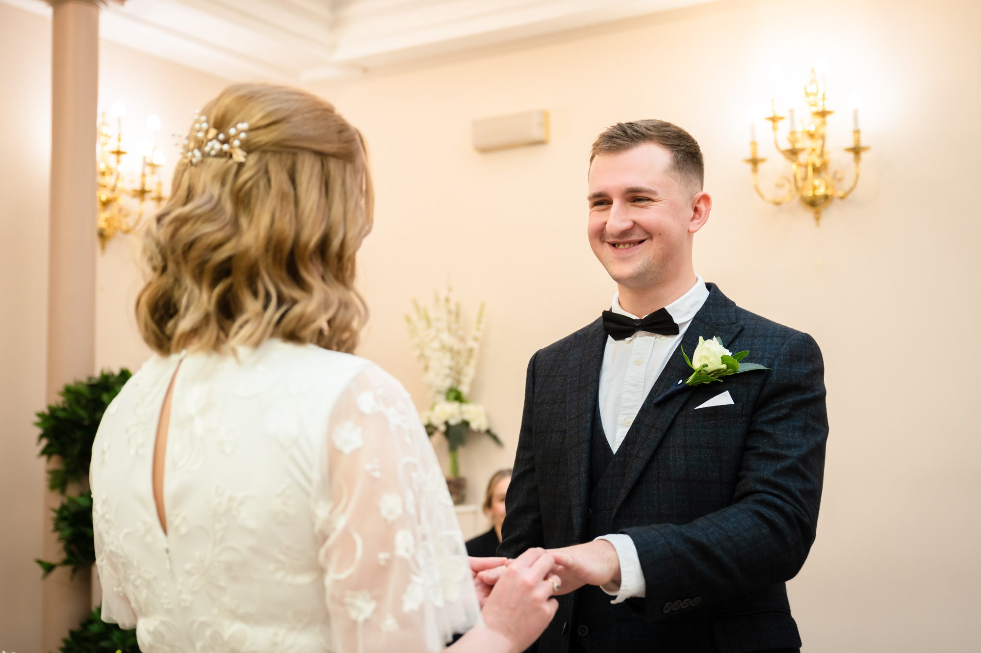 Bride putting on the groom's ring