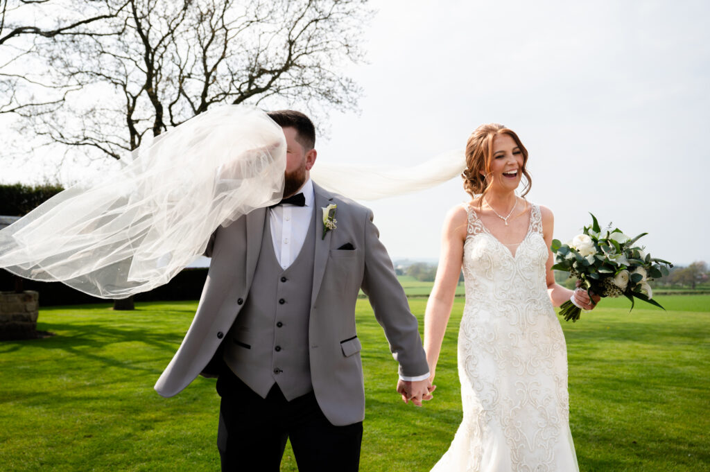 Groom catching the veil in his face