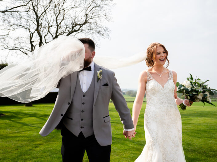 Groom catching the veil in his face