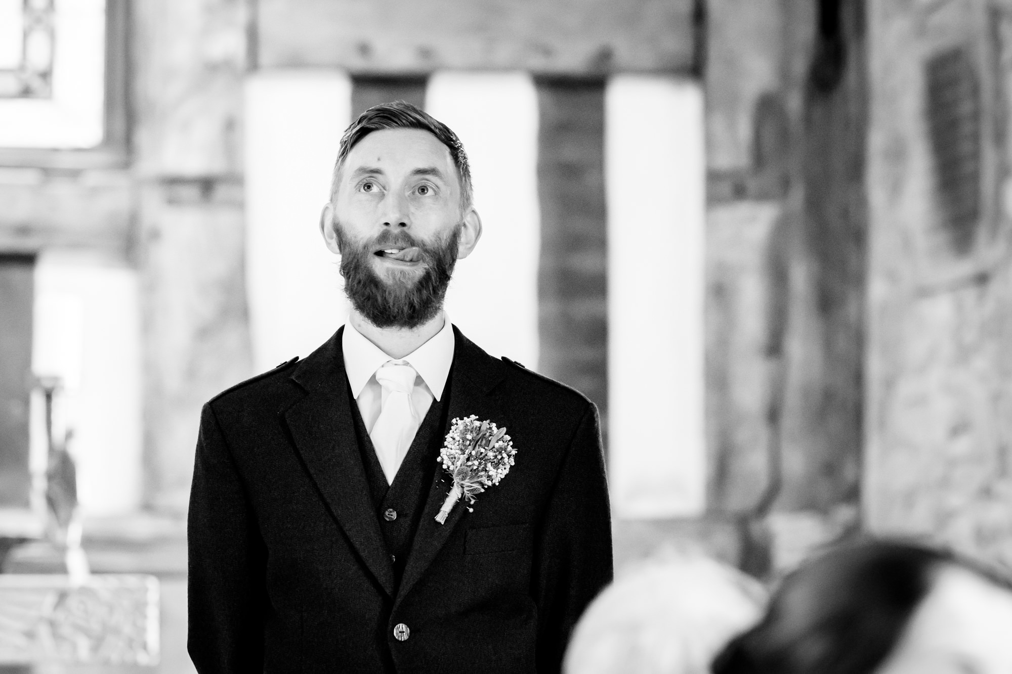 Groom waiting for the bride and sticking his tongue out at Chadkirk Chapel