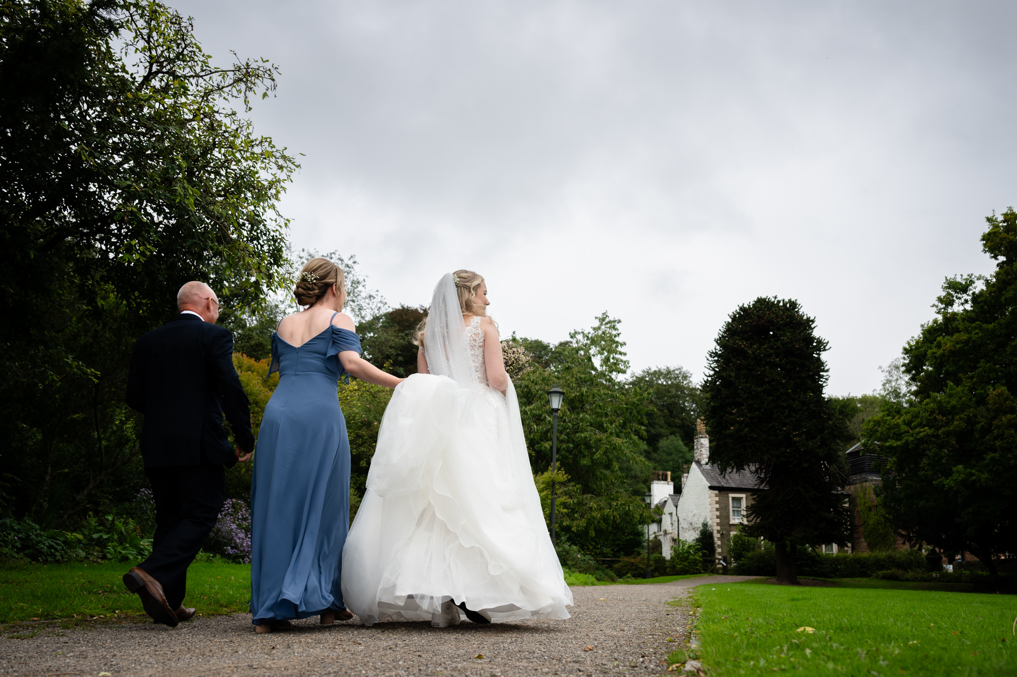 Bride walking towards Chadkirk Chapel