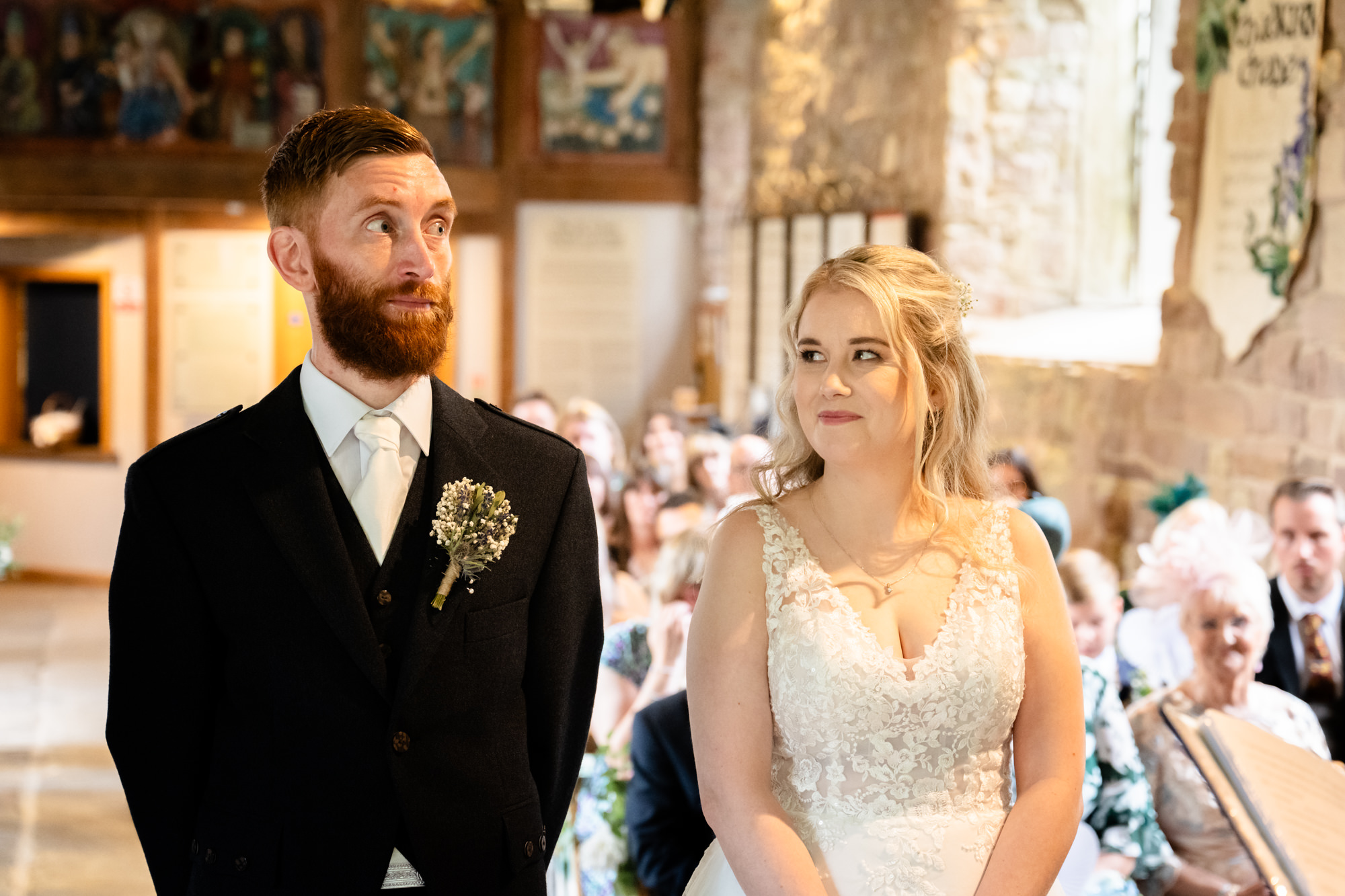 bride looking a the groom at Chadkirk Chapel