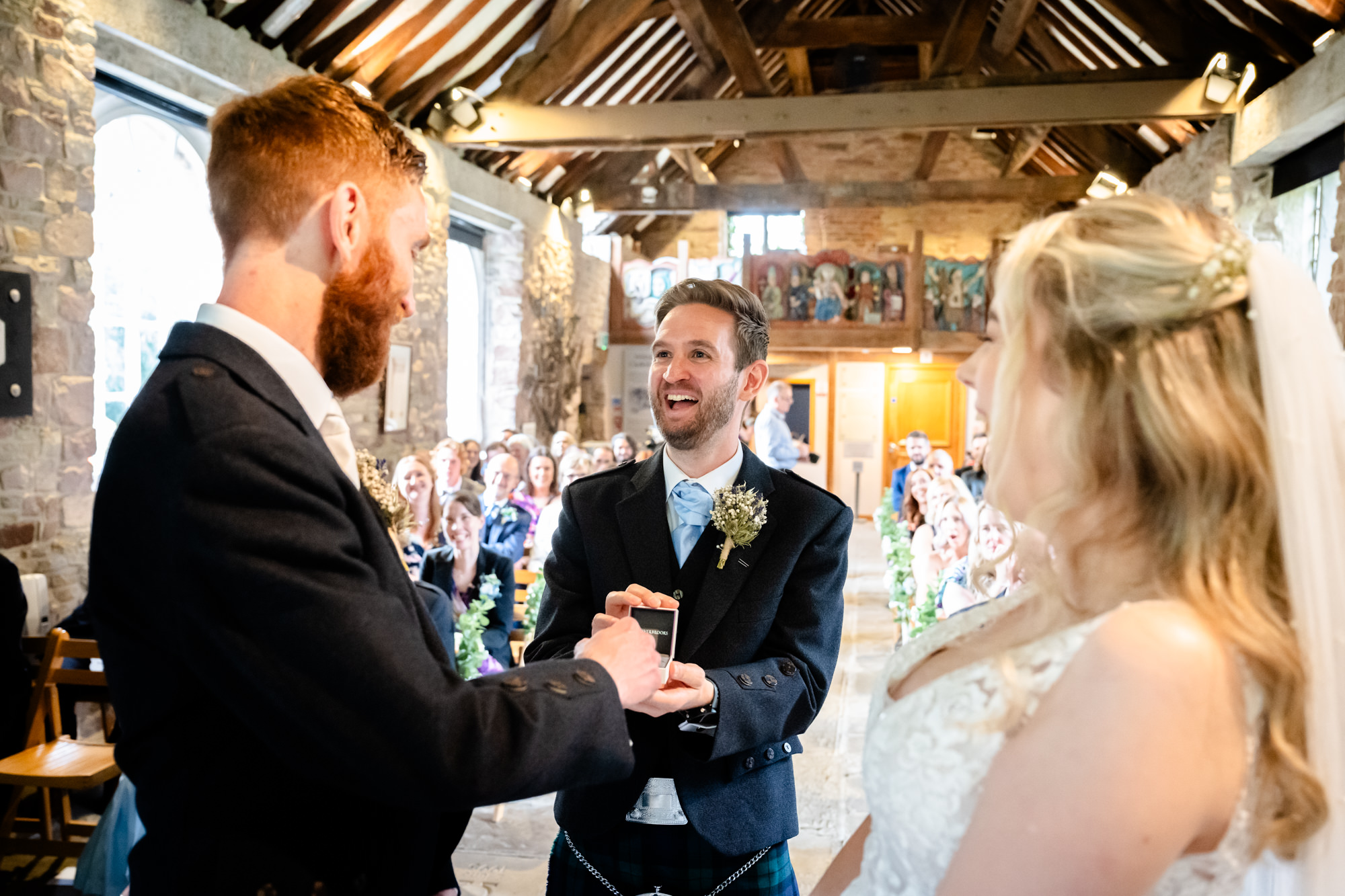 Best man presents the rings at Chadkirk Chapel