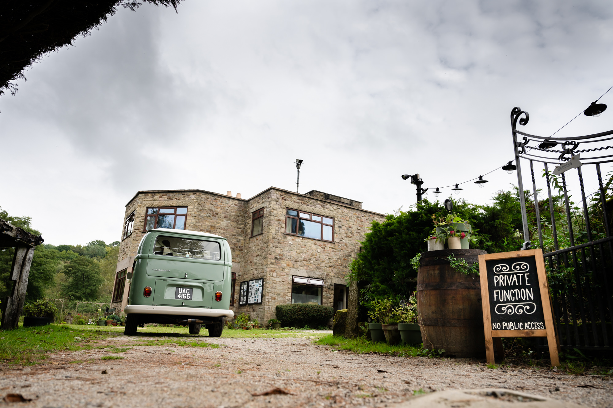 Bride and groom arriving in a VW campervan at The Roman Lakes