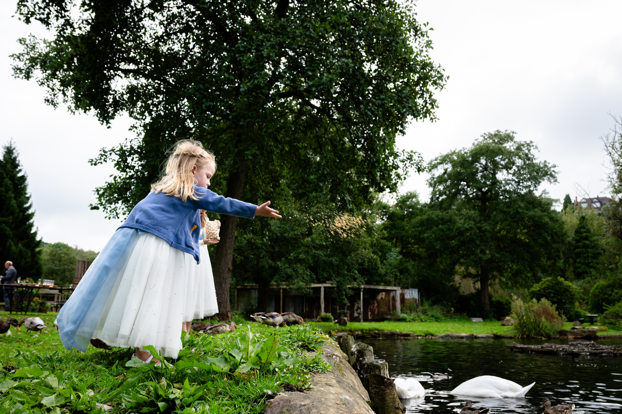 girl feeding the ducks at The Roman Lakes