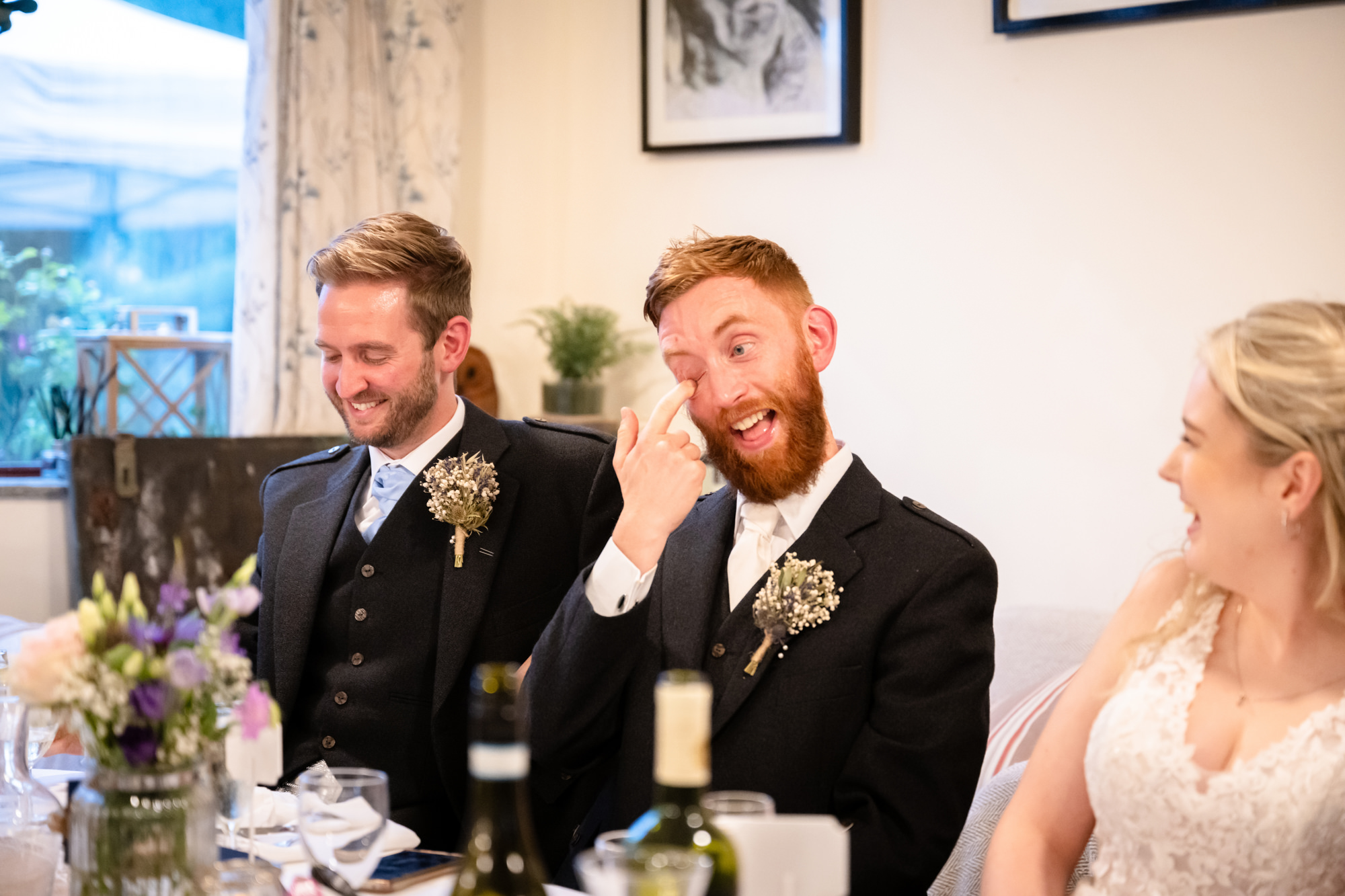 groom laughing during the speeches at The Roman Lakes