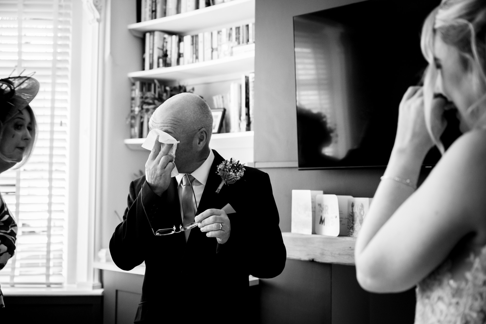 dad wipes his tears after seeing the bride