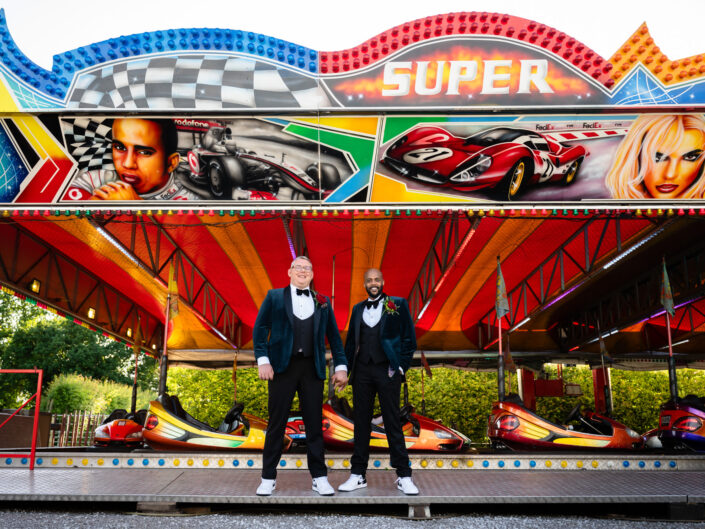 Grooms in front of the dodgem cars at Owen House Wedding Barn