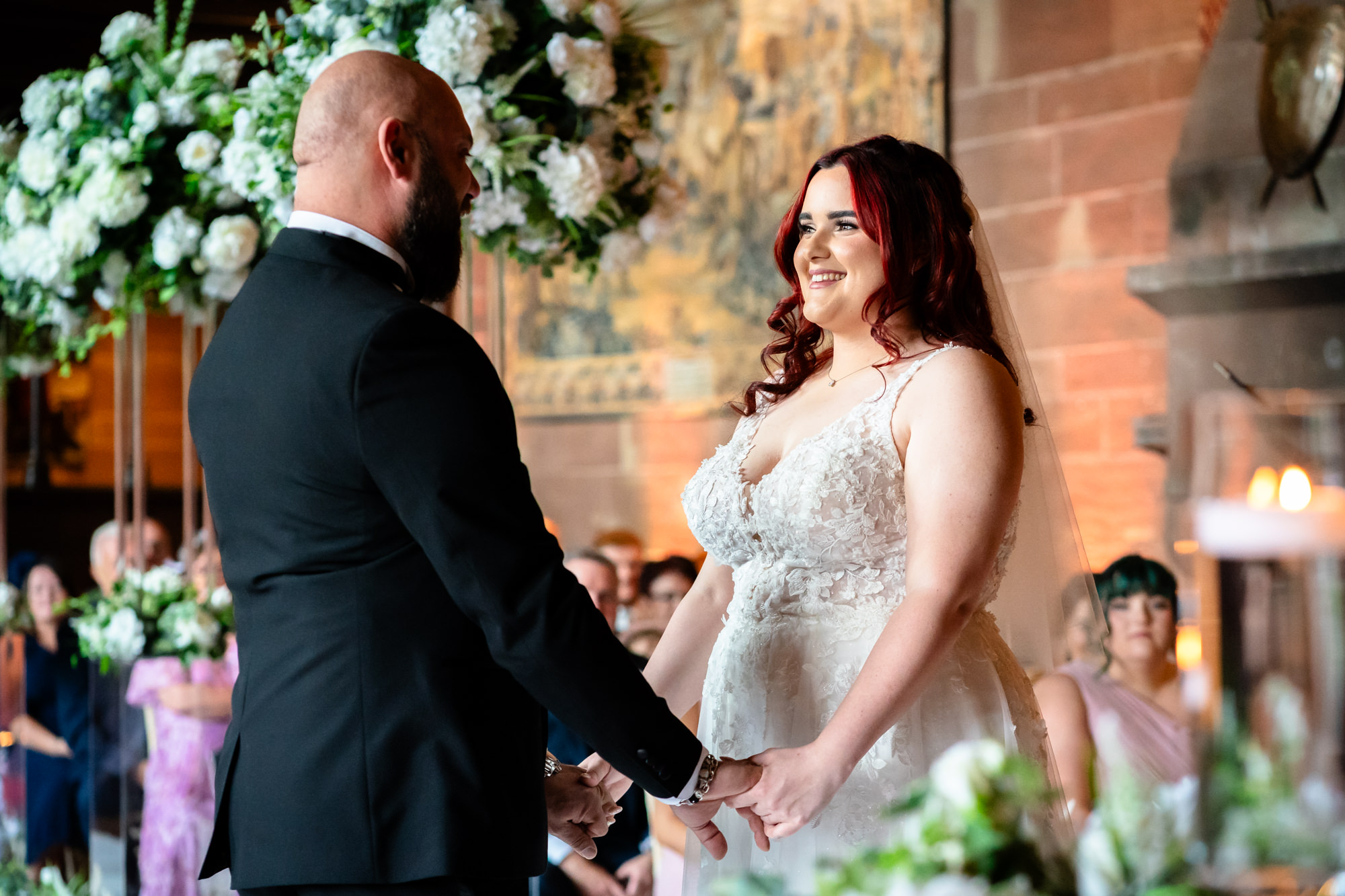 Bride and groom exchanging vows at Peckforton Castle