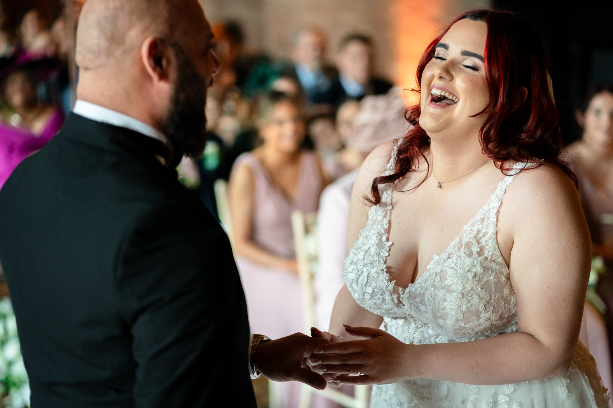 Bride laughing during the ring exchange at Peckforton Castle