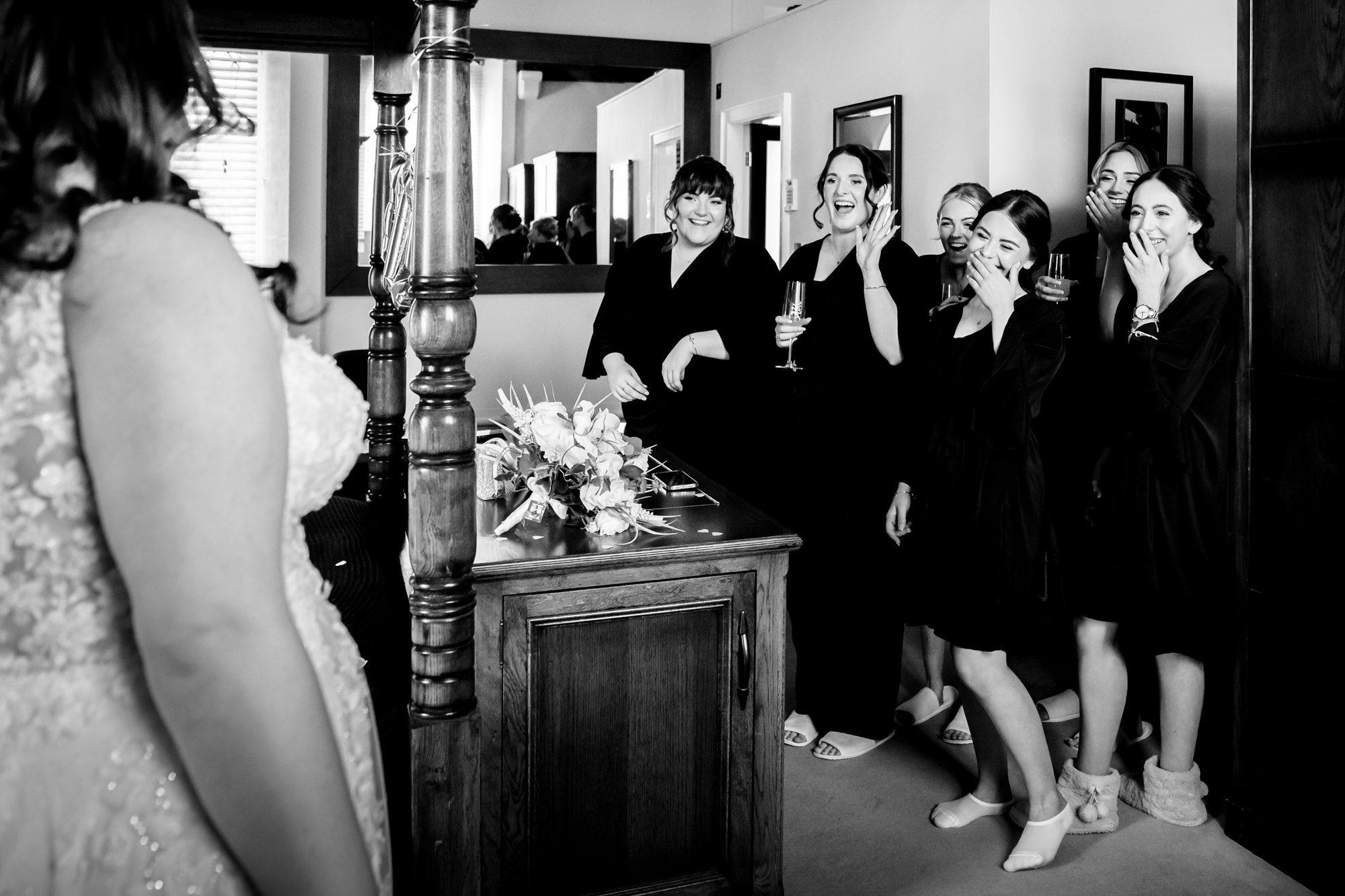 Bridesmaids see the bride in her dress for the first time at Peckforton Castle