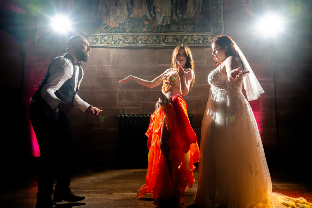 Belly dancer performing with the bride and groom