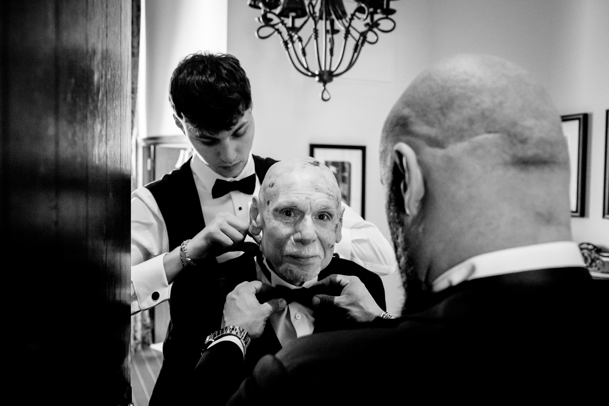 Groom adjusting his dad's bowtie at Peckforton Castle