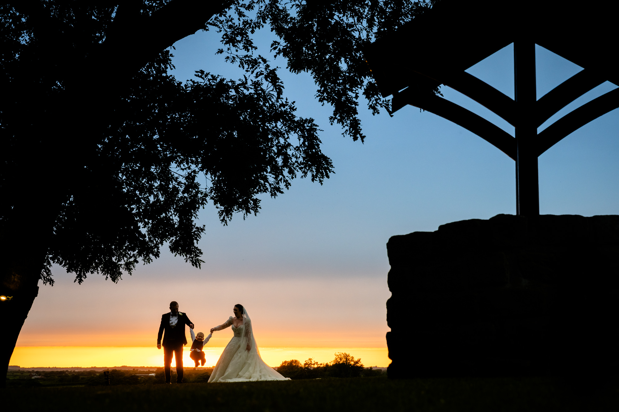 Bride and groom sunset photo with their toddler at West Tower