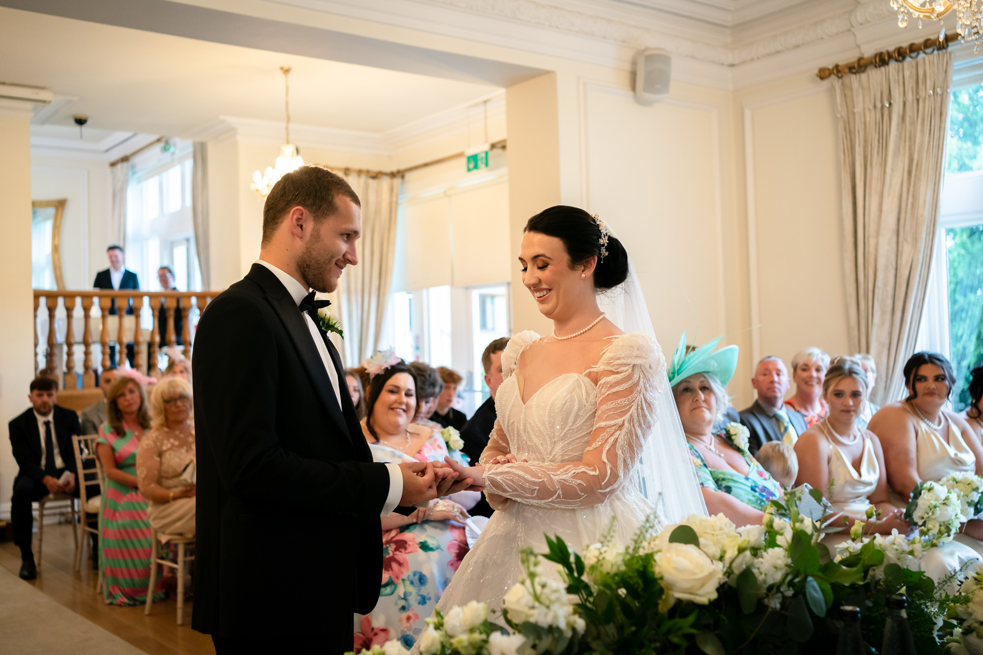 Groom putting on the bride's ring at West Tower