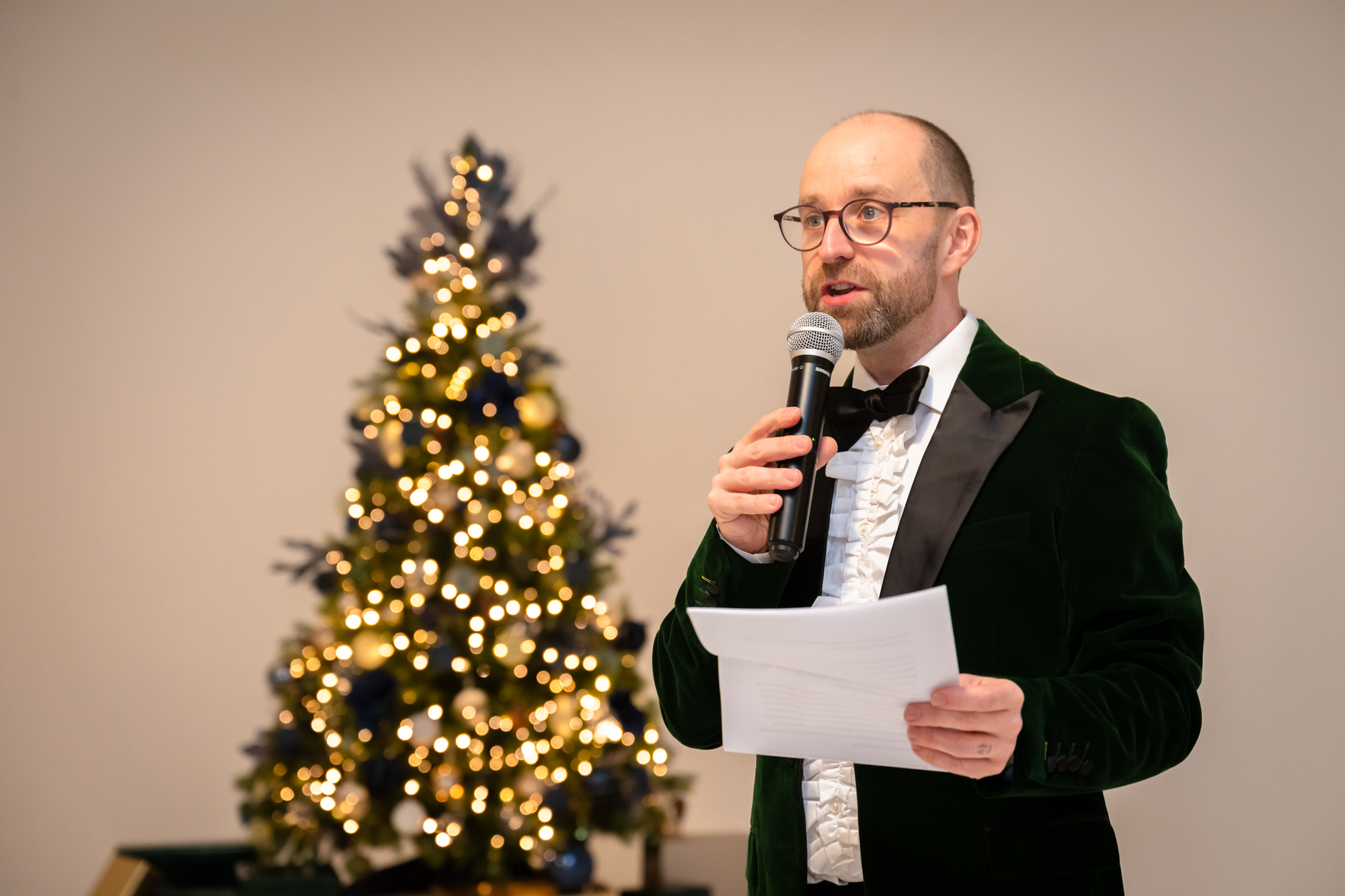 Grooms speech at Fabric Studio . The background has a Christmas tree