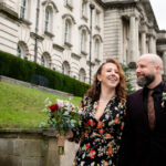 Bride and groom walking outside Stockport Town Hall