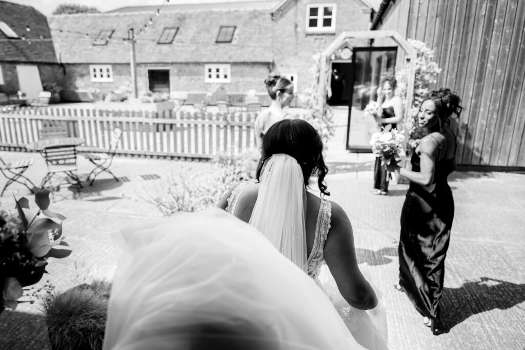 Bride stepping out the dressing room at Hanbury Barns