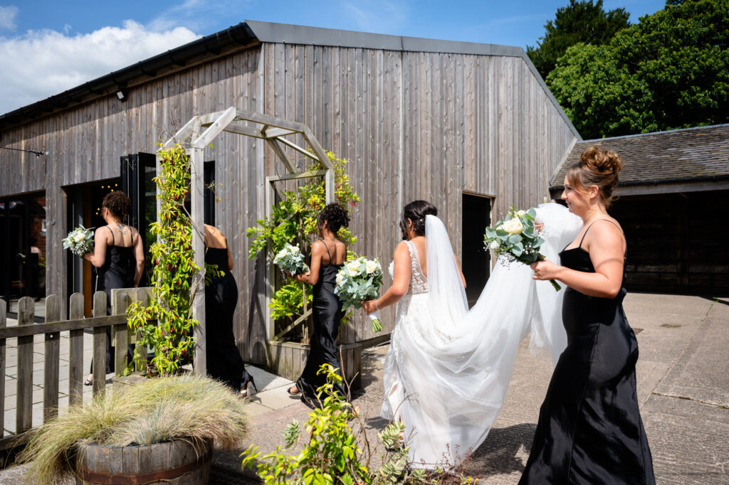 Bride heading to the ceremony at Hanbury Barns