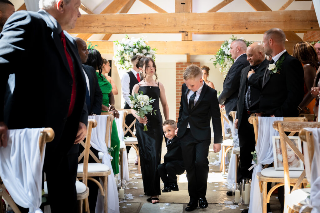 Paige boy being carried down the aisle at Hanbury Barns