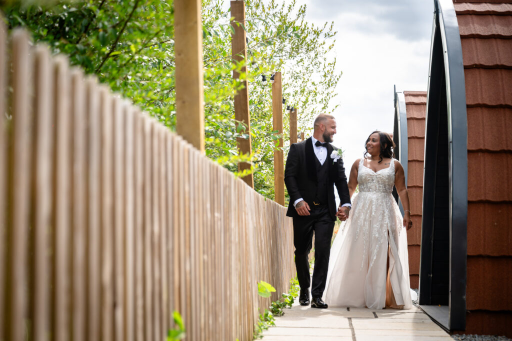 Bride and groom walking around Hanbury Barns