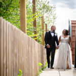 Bride and groom walking around Hanbury Barns