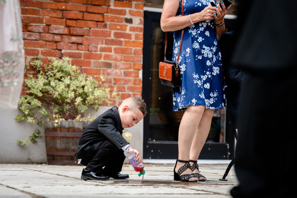 child pouring out a bottle of juice