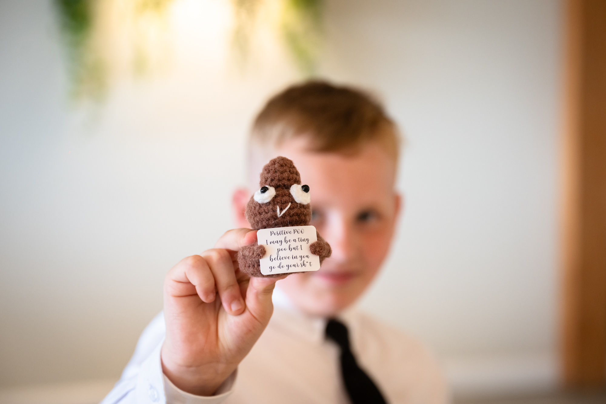 boy showing his crocheted poo