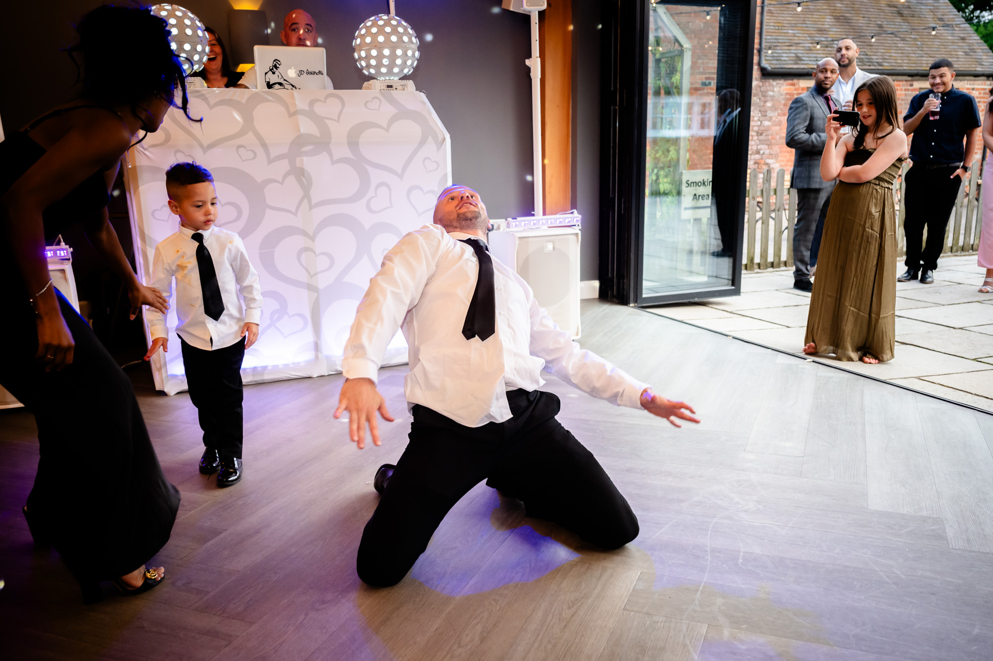 Best man on his knees on the dancefloor at Hanbury Barns