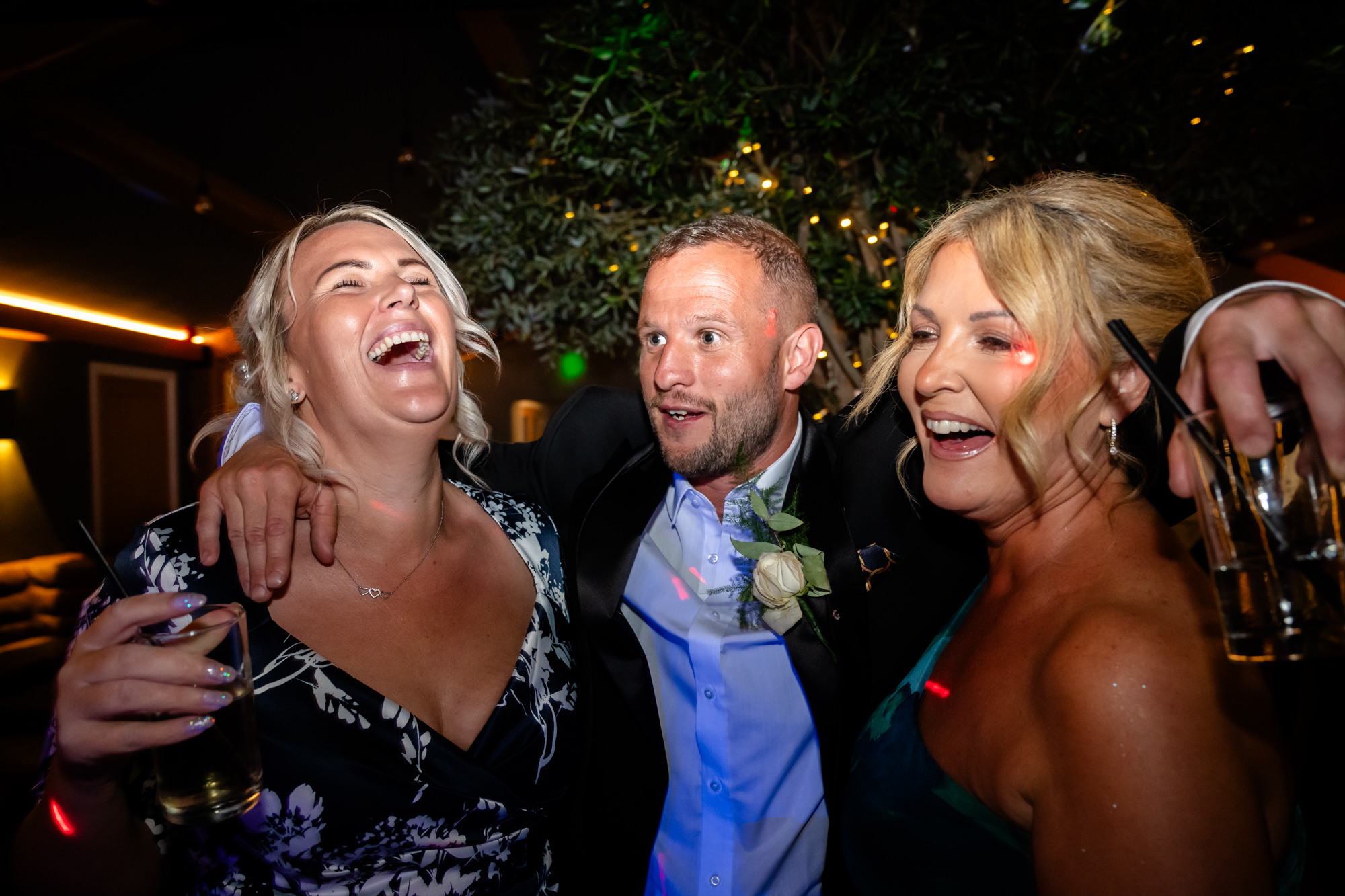 Three guest dancing and singing together at Hanbury Barns