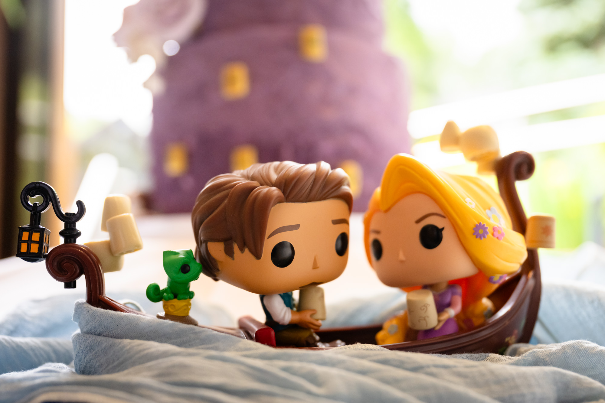 Close-up of Funko Pop figures of the bride and groom, and other characters, displayed as part of the wedding decorations at Moddershall Oaks, consistent with Disney's Tangled-themed wedding details.