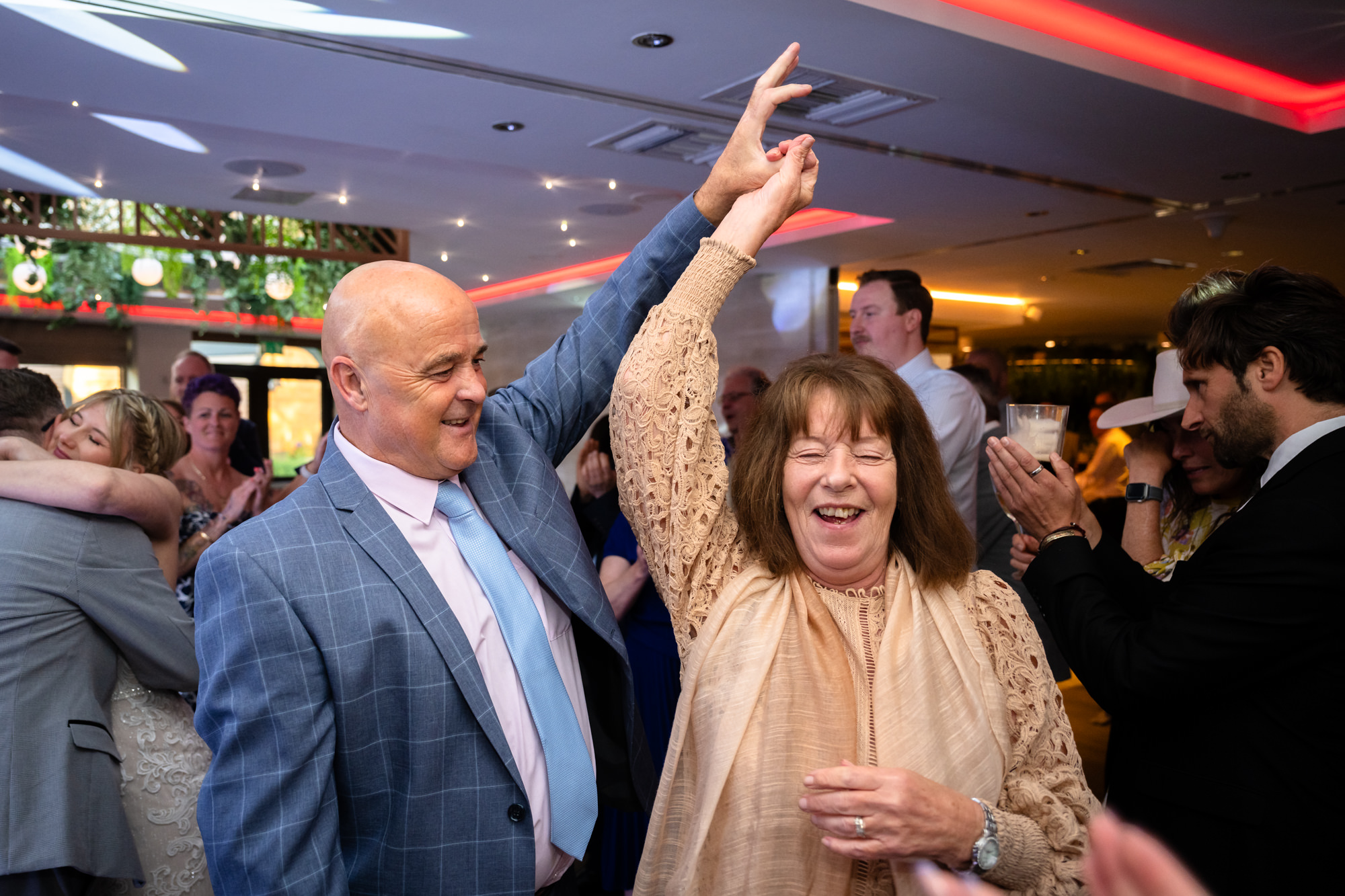 A man spinning his wife on the dancefoor